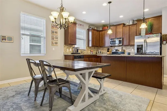 a living room with furniture and a ceiling fan