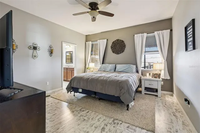 a bedroom with a bed and a refrigerator