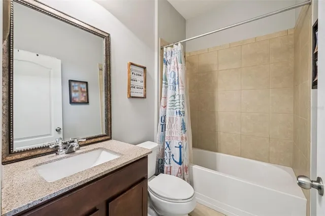 an outdoor sitting area with couch and wooden fence