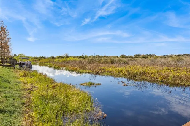 an aerial view of a house with outdoor space and lake view