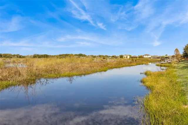 an aerial view of a house with outdoor space and lake view