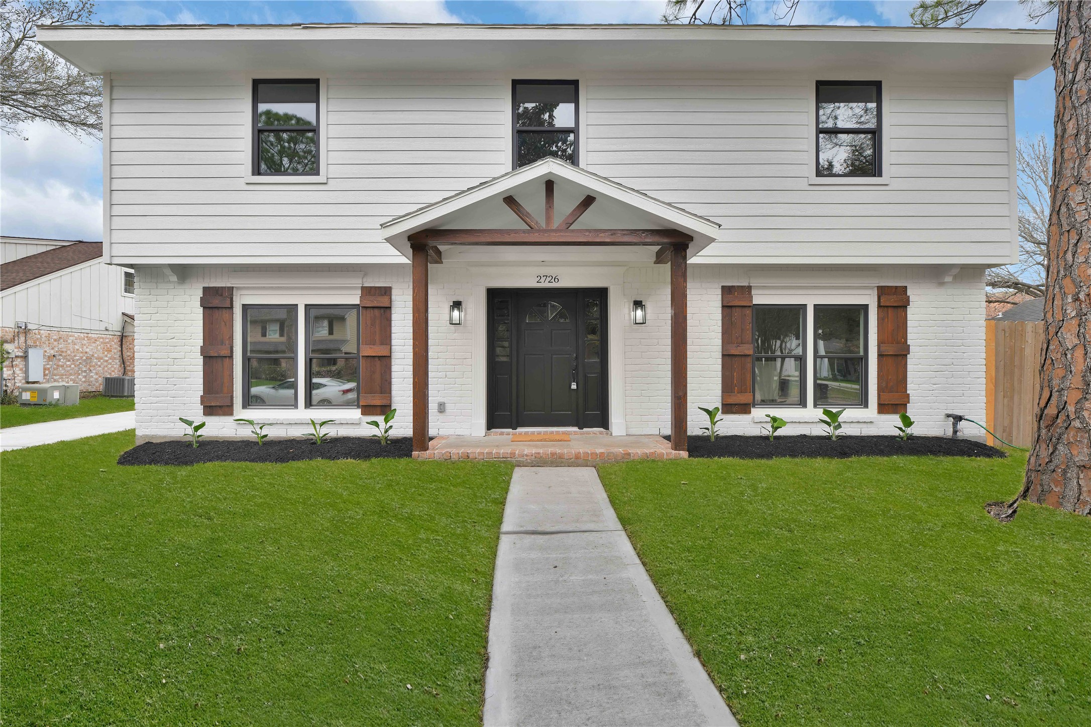 a front view of a house with a yard