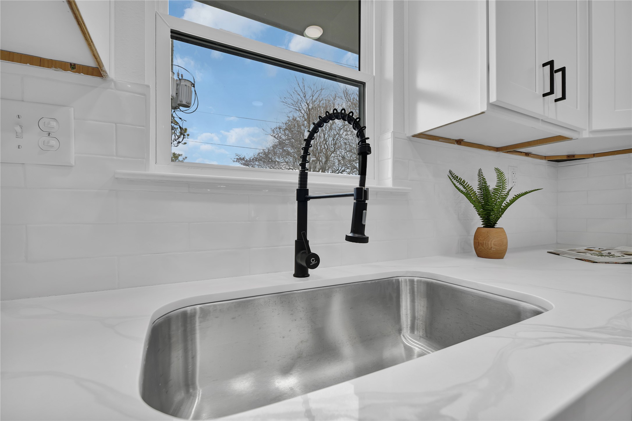 2726 Stetson Lane Houston, TX 77043 - Photo 16 of 36 A charming farmhouse-style stainless sink complemented by an upgraded gooseneck faucet for effortless daily use.
