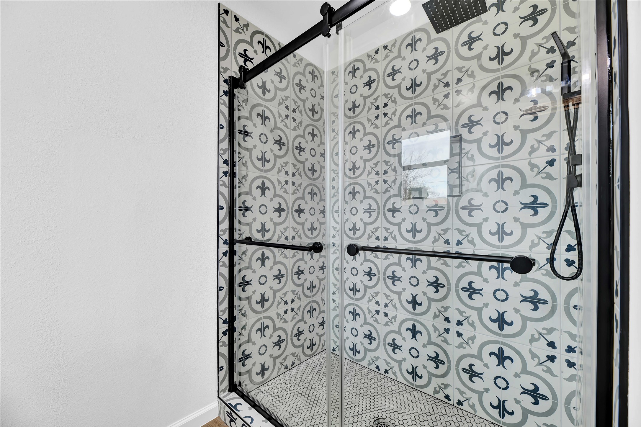 2726 Stetson Lane Houston, TX 77043 - Photo 26 of 36 Spa-inspired primary shower with sliding glass enclosure, updated fixtures, and modern tile finishes.