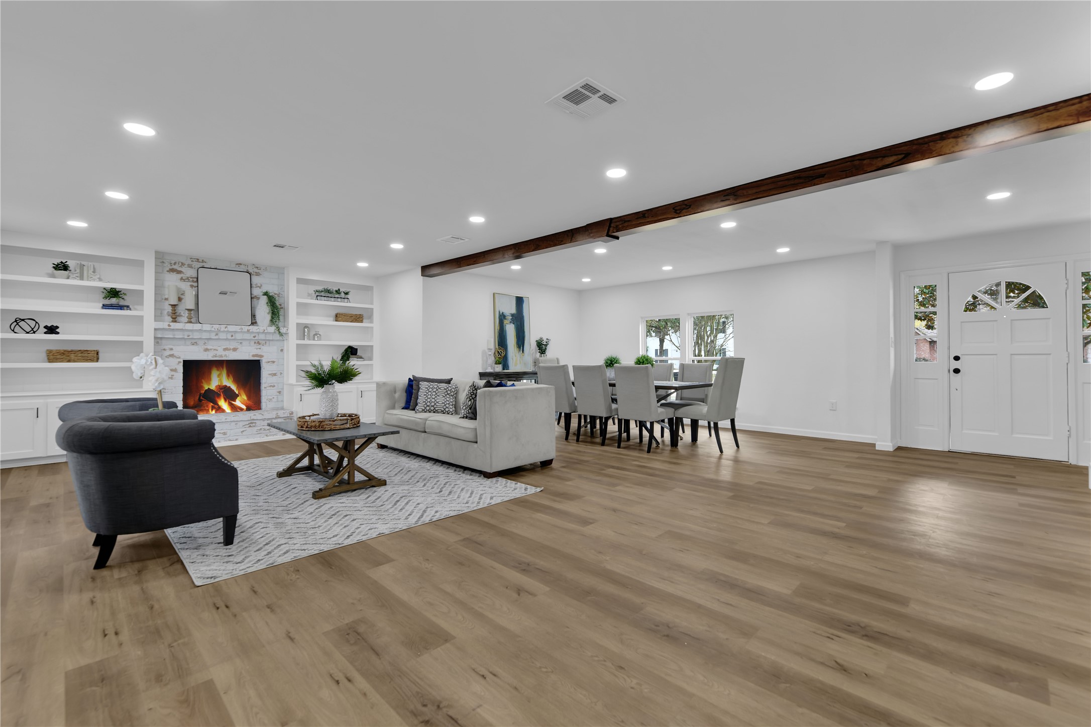 2726 Stetson Lane Houston, TX 77043 - Photo 8 of 36 Open living space with a cozy fireplace, perfect for comfort and gatherings.