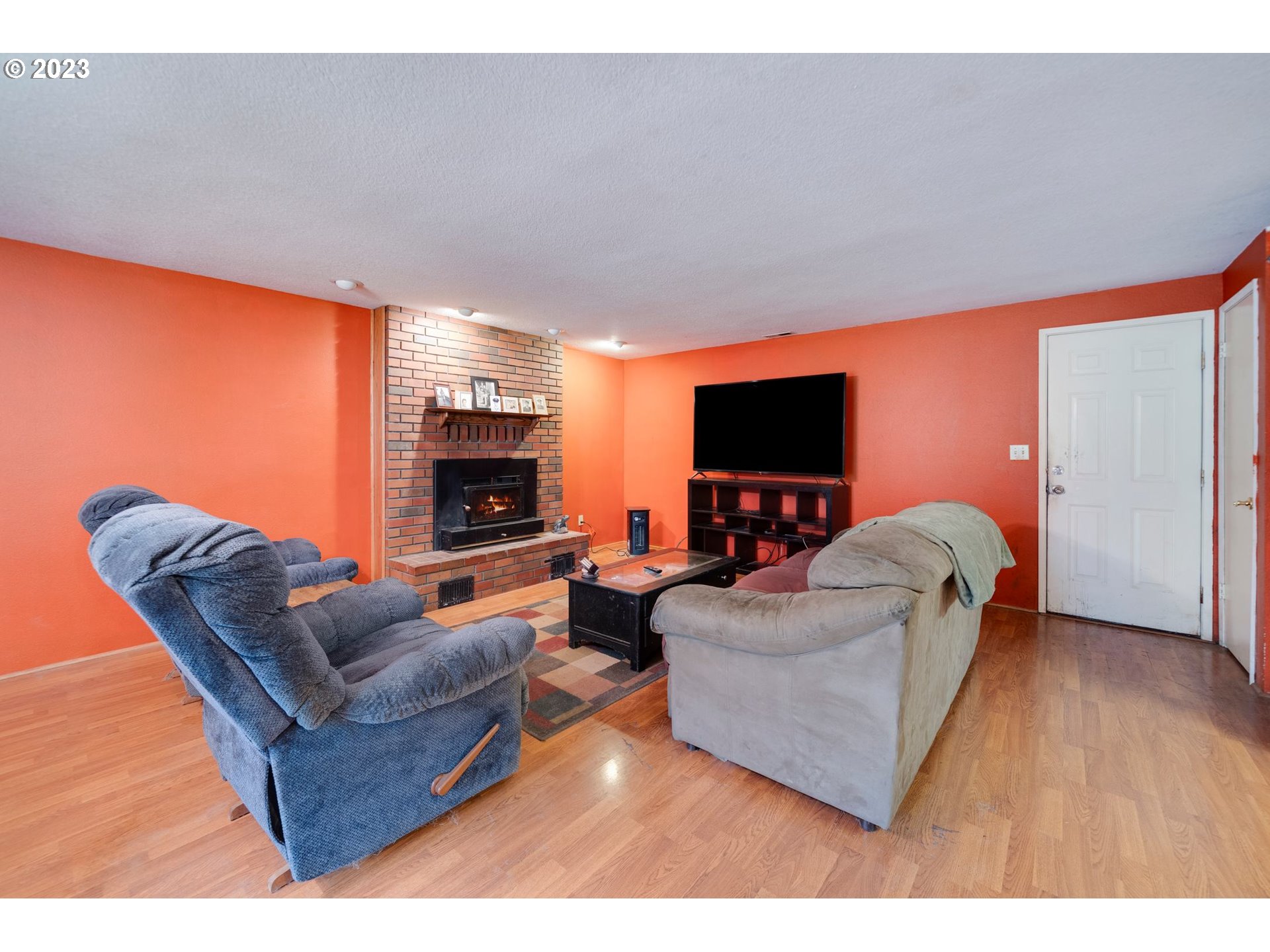 17802 Northeast 219th Street Battle Ground, WA 98604 - Photo 14 of 42 a living room with furniture a flat screen tv and a fireplace
