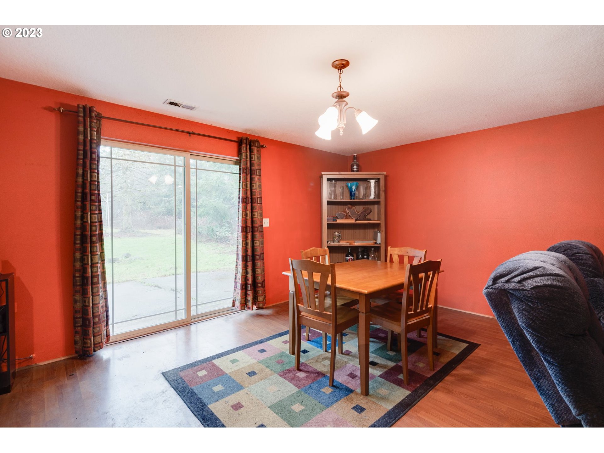 17802 Northeast 219th Street Battle Ground, WA 98604 - Photo 16 of 42 a dining room with furniture a chandelier and wooden floor