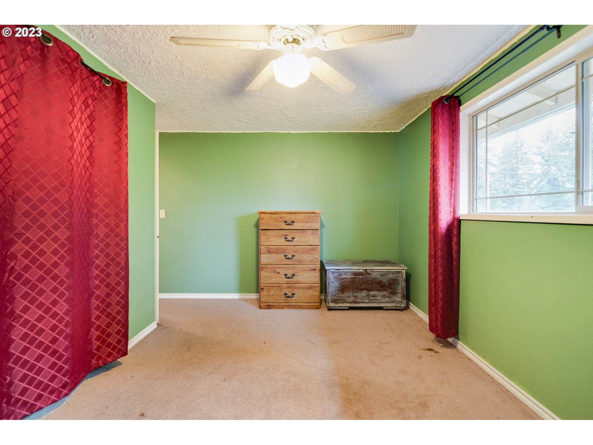 17802 Northeast 219th Street Battle Ground, WA 98604 - Photo 20 of 42 a bedroom with a bed and a chandelier