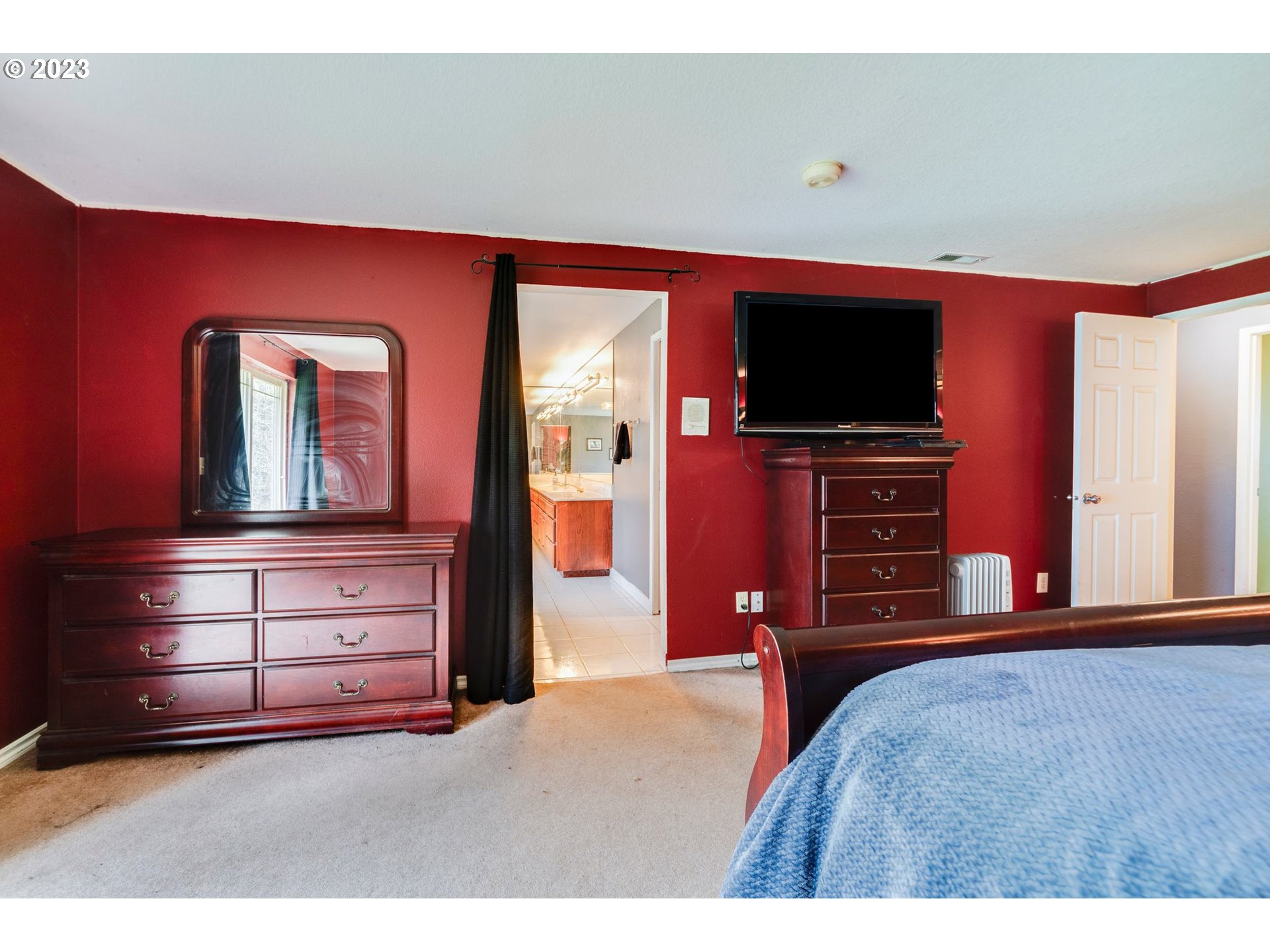 17802 Northeast 219th Street Battle Ground, WA 98604 - Photo 23 of 42 a bedroom with a bed and a television in it