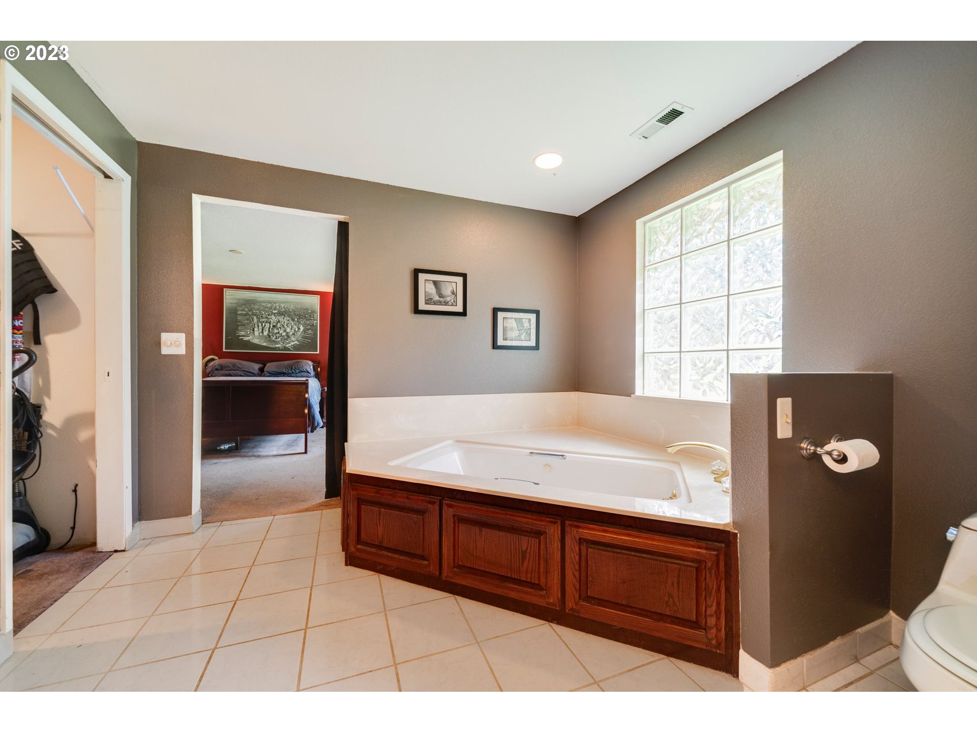 17802 Northeast 219th Street Battle Ground, WA 98604 - Photo 26 of 42 a spacious bathroom with a granite countertop sink a toilet and mirror