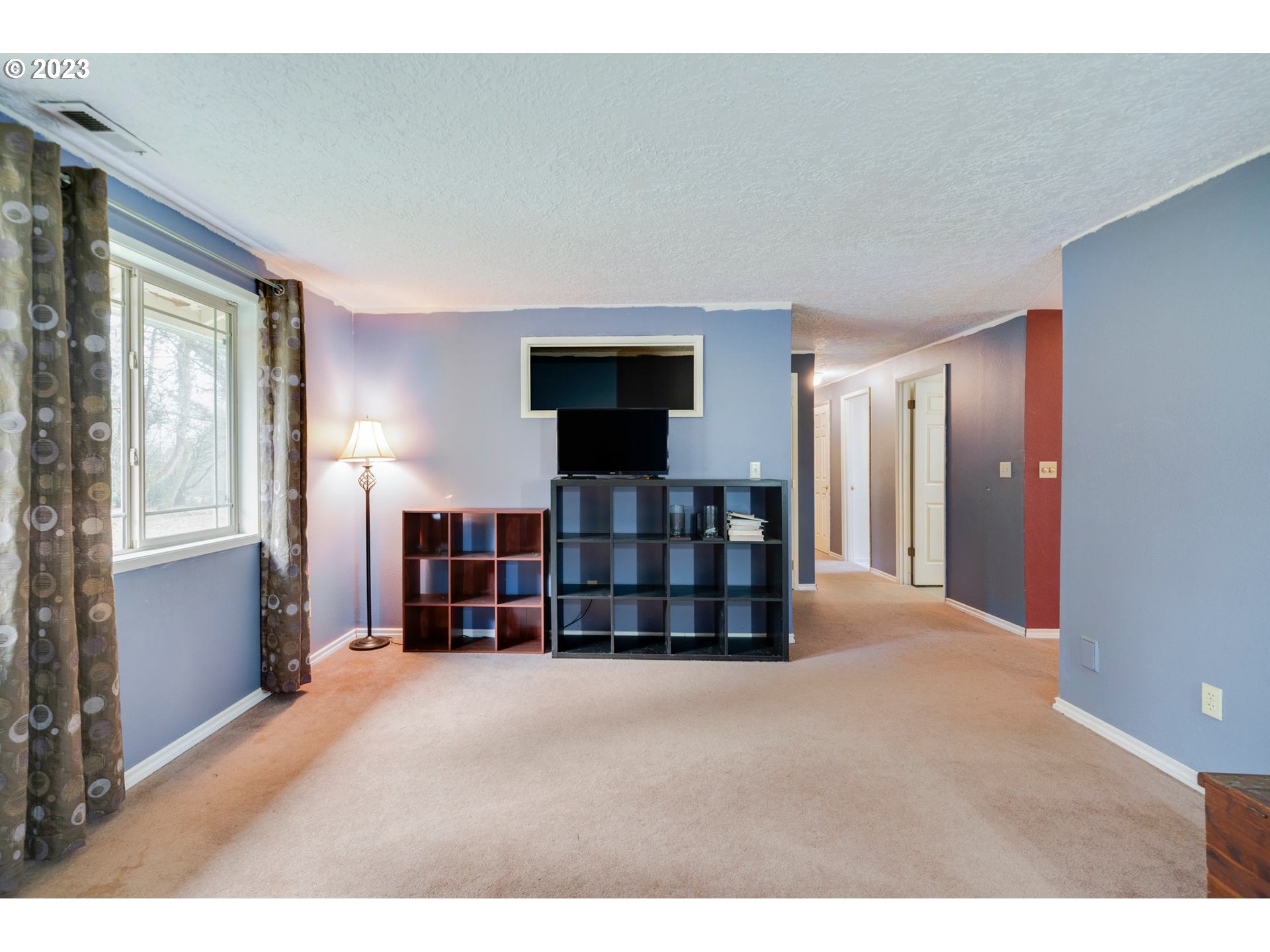 17802 Northeast 219th Street Battle Ground, WA 98604 - Photo 7 of 42 a living room with furniture and a flat screen tv