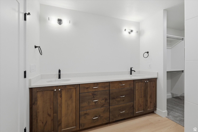 844 North 400 West Logan, UT 84321 - Photo 23 of 43 Dual basin vanity with a white countertop, dark wood-finish cabinetry, and matte black fixtures