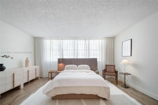 a bedroom with a bed and a chair