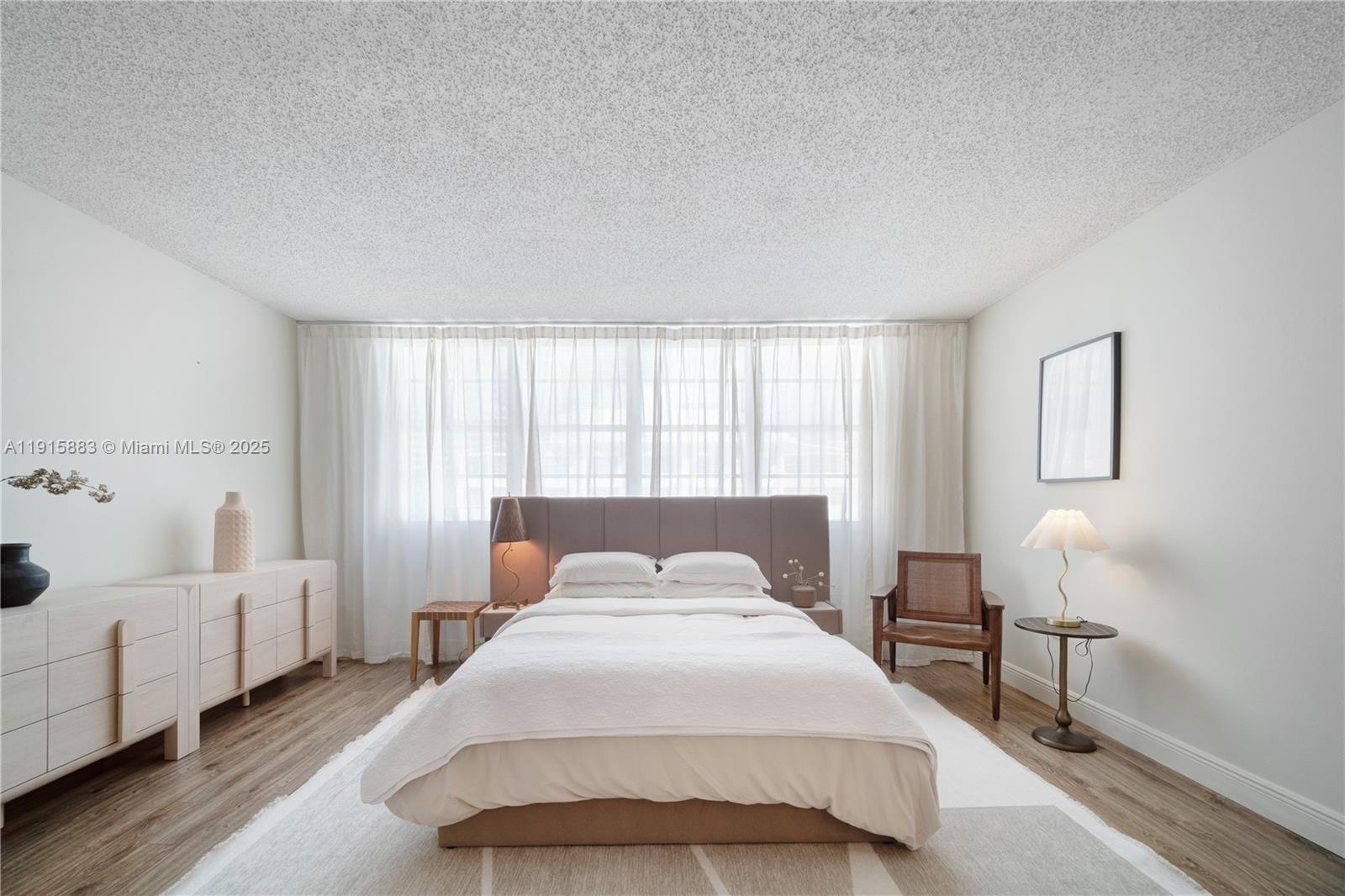 a bedroom with a bed and a chair