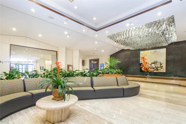 a living room with furniture and flowers