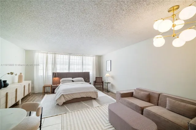 a bedroom with a bed couch and window