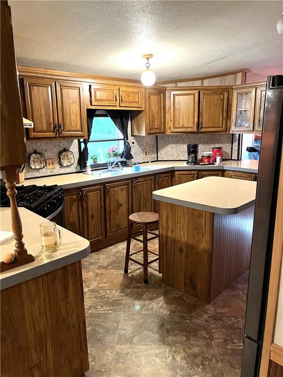 304 Mutton Hollow Road Rural Valley, PA 16249 - Photo 3 of 12 a kitchen with stainless steel appliances granite countertop sink stove refrigerator and cabinets
