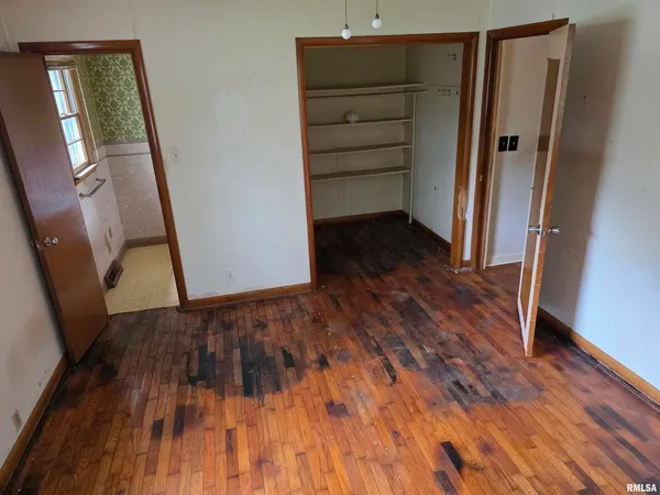 a view of walk in closet with wooden floor and staircase