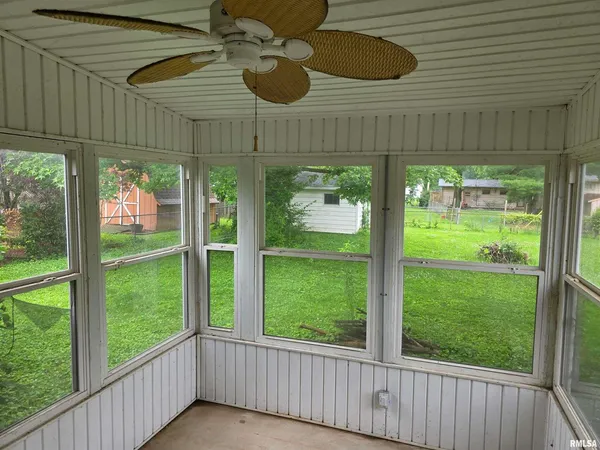 a view of a room with wooden floor closet and windows