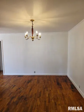 an empty room with wooden floor