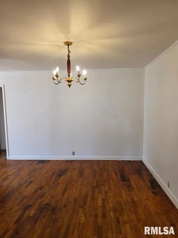 an empty room with wooden floor