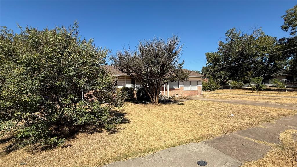 12225 Schroeder Road Dallas, TX 75243 - Photo 3 of 40 Front yard with established trees and a sidewalk