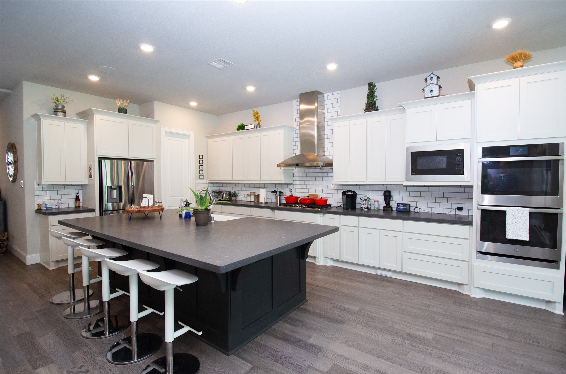 4143 Shackleton Court Iowa Colony, TX 77583 - Photo 6 of 34 This stunning kitchen features ample white cabinets, stainless steel appliances and a large island creating a perfect space for cooking and entertaining.