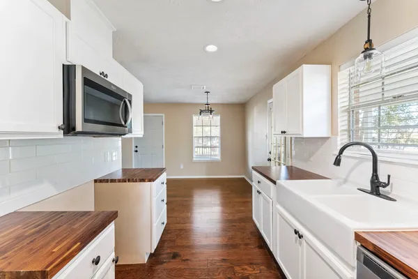 a kitchen with sink a microwave and stove