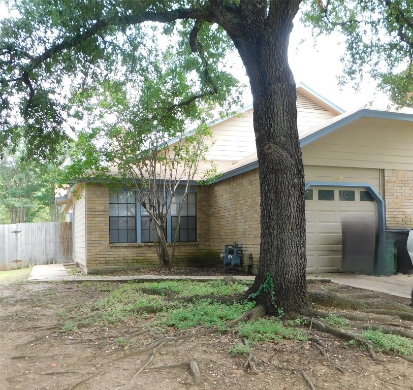 2027 Redwing Way Round Rock, TX 78664 - Photo 1 of 13 a front view of a house with garden