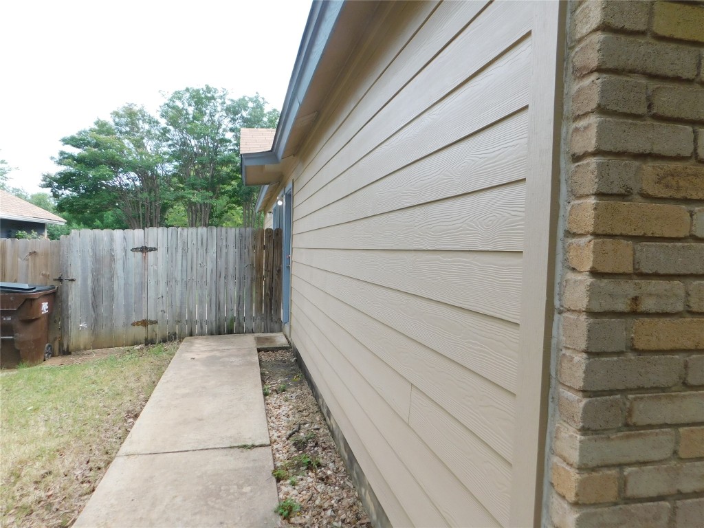 2027 Redwing Way Round Rock, TX 78664 - Photo 2 of 13 a backyard of a house with wooden fence