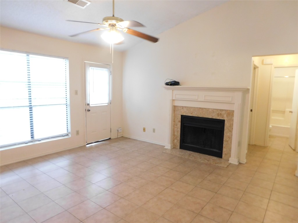 2027 Redwing Way Round Rock, TX 78664 - Photo 3 of 13 an empty room with windows and fireplace