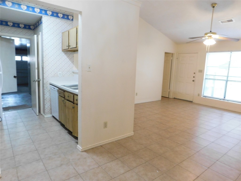 2027 Redwing Way Round Rock, TX 78664 - Photo 8 of 13 wooden floor in an empty room with a kitchen