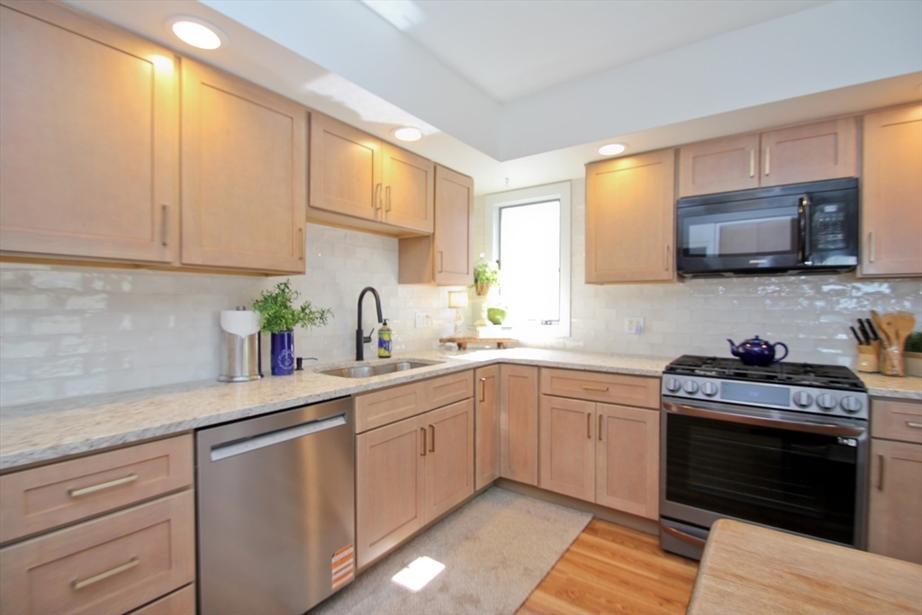 38 Virginia Street Springfield, MA 01108 - Photo 16 of 42 a kitchen with a sink stove and microwave