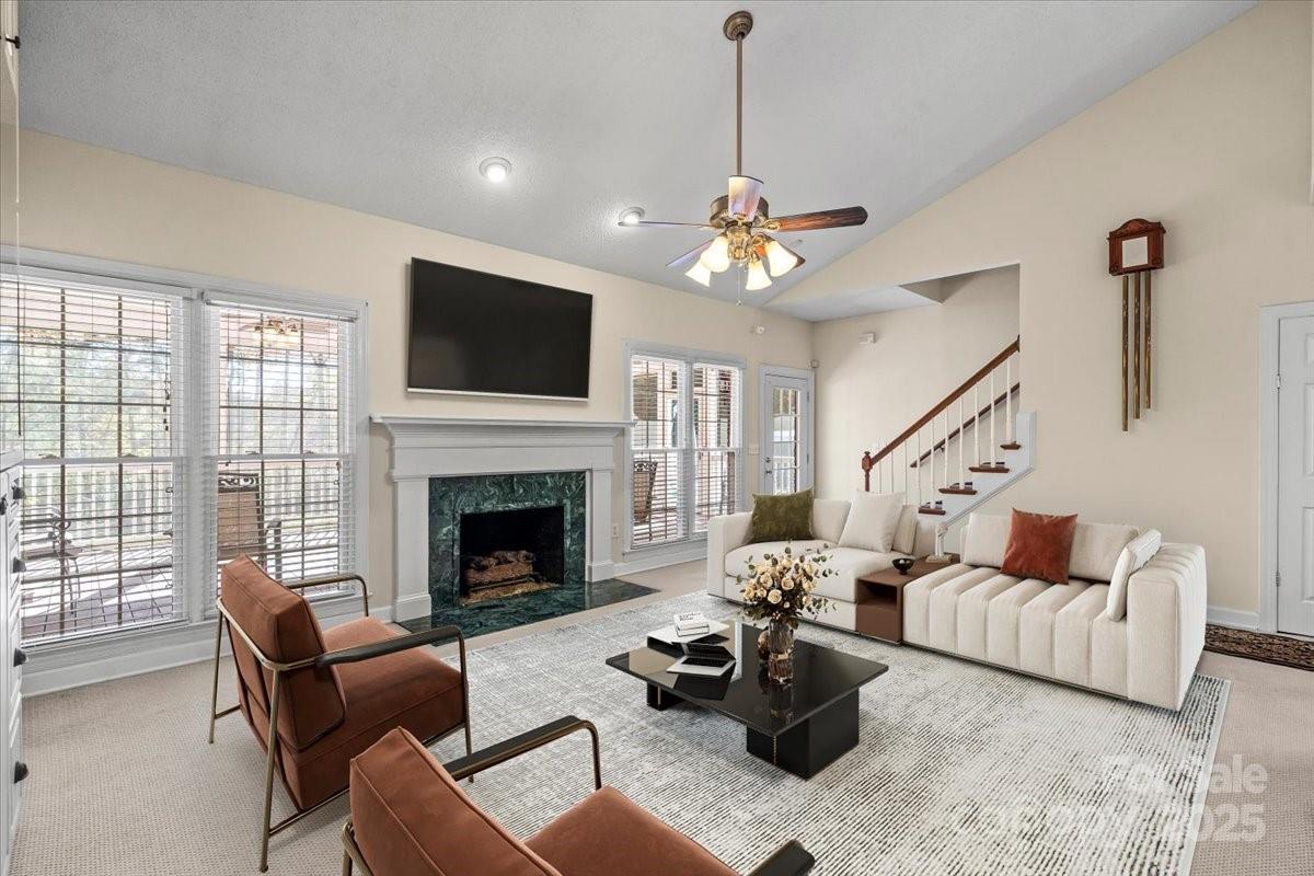 5619 Weddington Road Concord, NC 28027 - Photo 11 of 48 a living room with furniture a flat screen tv and a fireplace