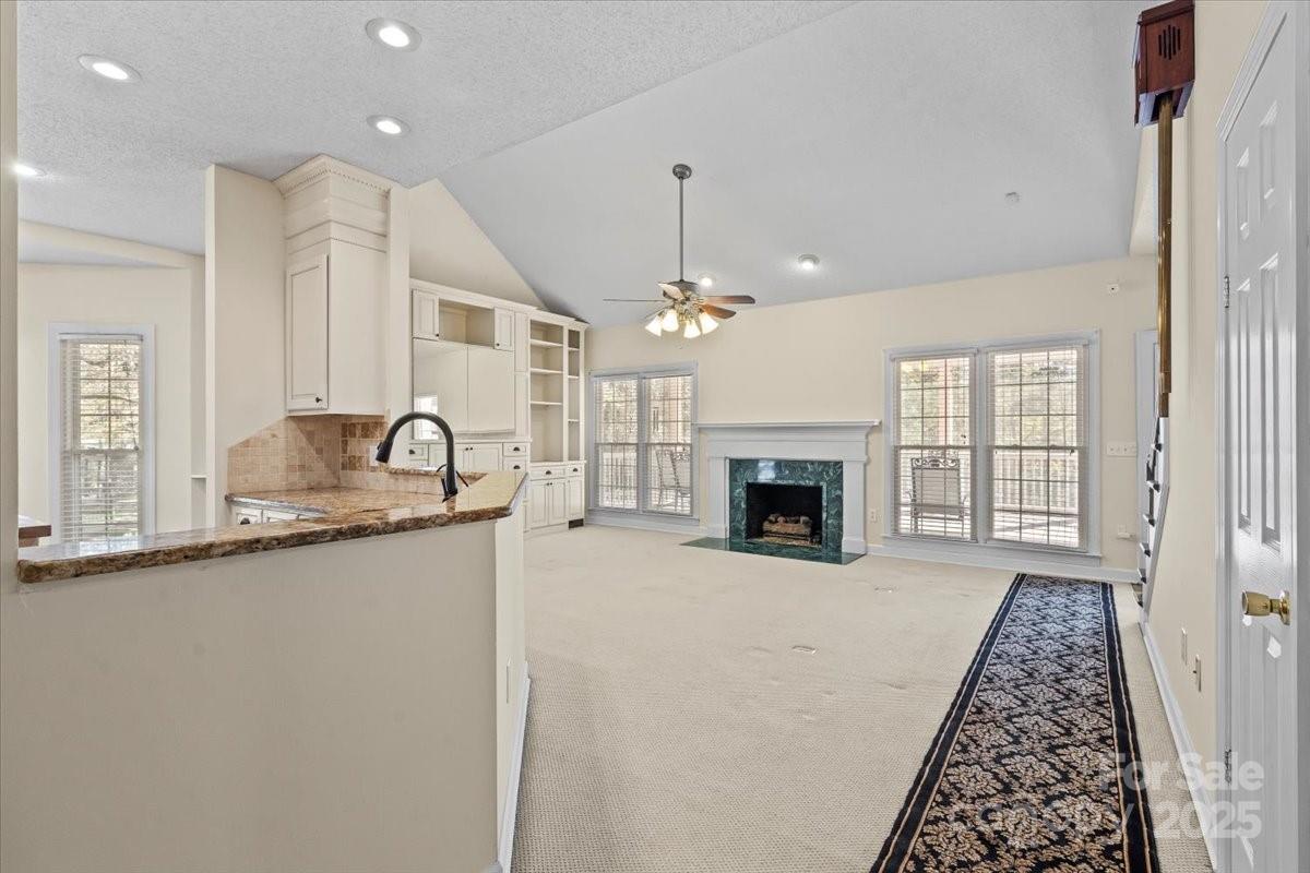 5619 Weddington Road Concord, NC 28027 - Photo 14 of 48 a large kitchen with sink a mirror and a stove