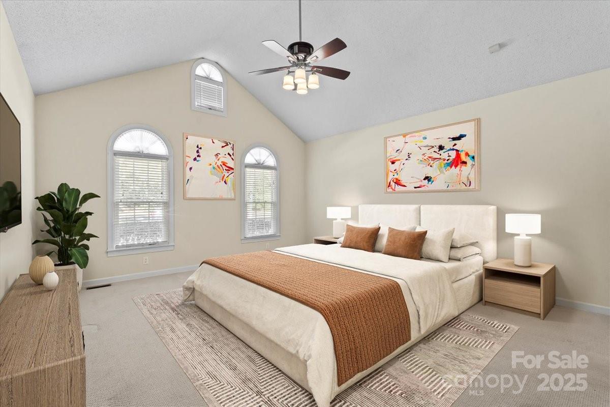 5619 Weddington Road Concord, NC 28027 - Photo 20 of 48 a spacious bedroom with a bed and a chandelier