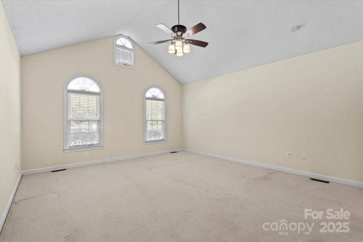 5619 Weddington Road Concord, NC 28027 - Photo 21 of 48 an empty room with chandelier fan and windows
