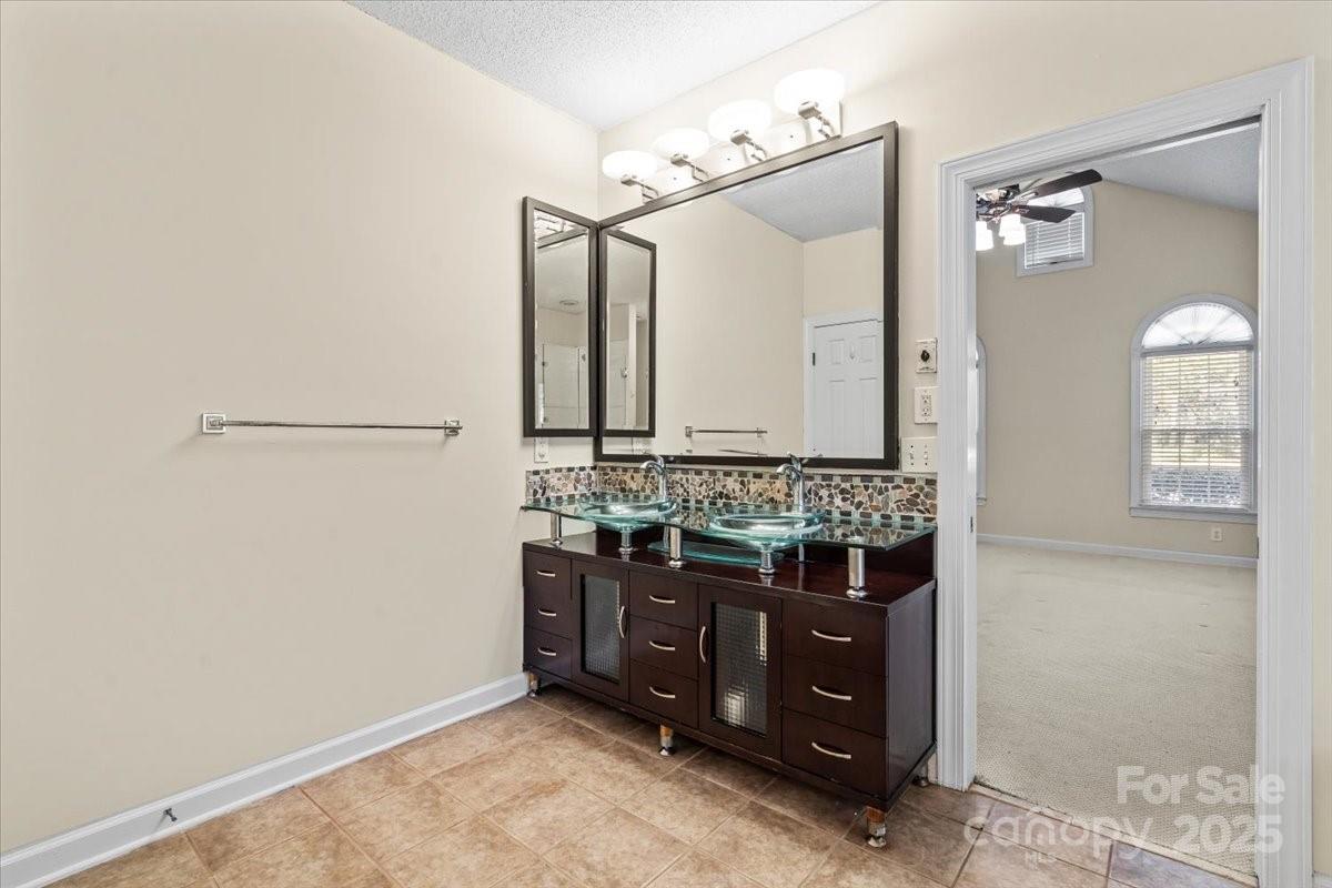 5619 Weddington Road Concord, NC 28027 - Photo 24 of 48 a bathroom with a sink and a mirror