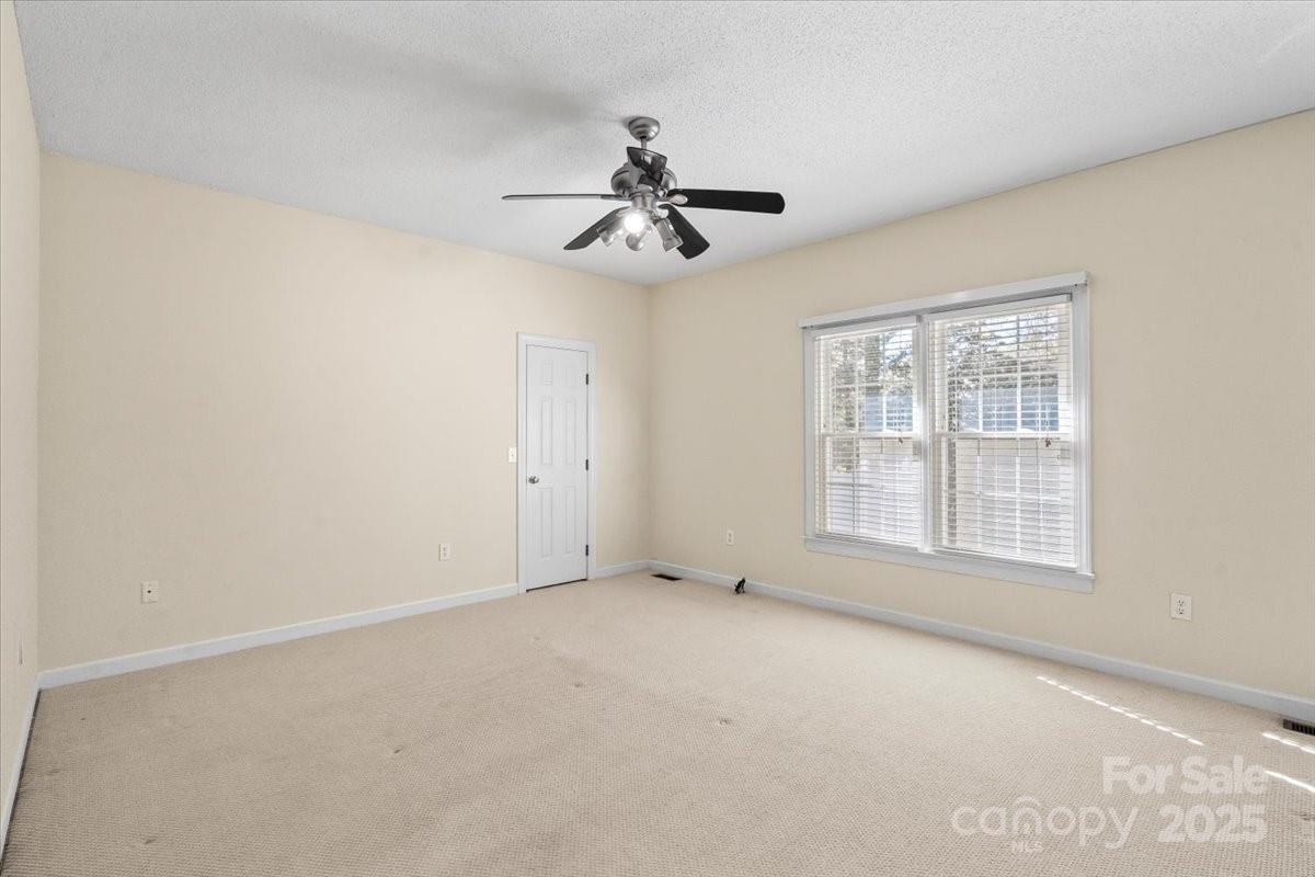 5619 Weddington Road Concord, NC 28027 - Photo 27 of 48 an empty room with windows and fan