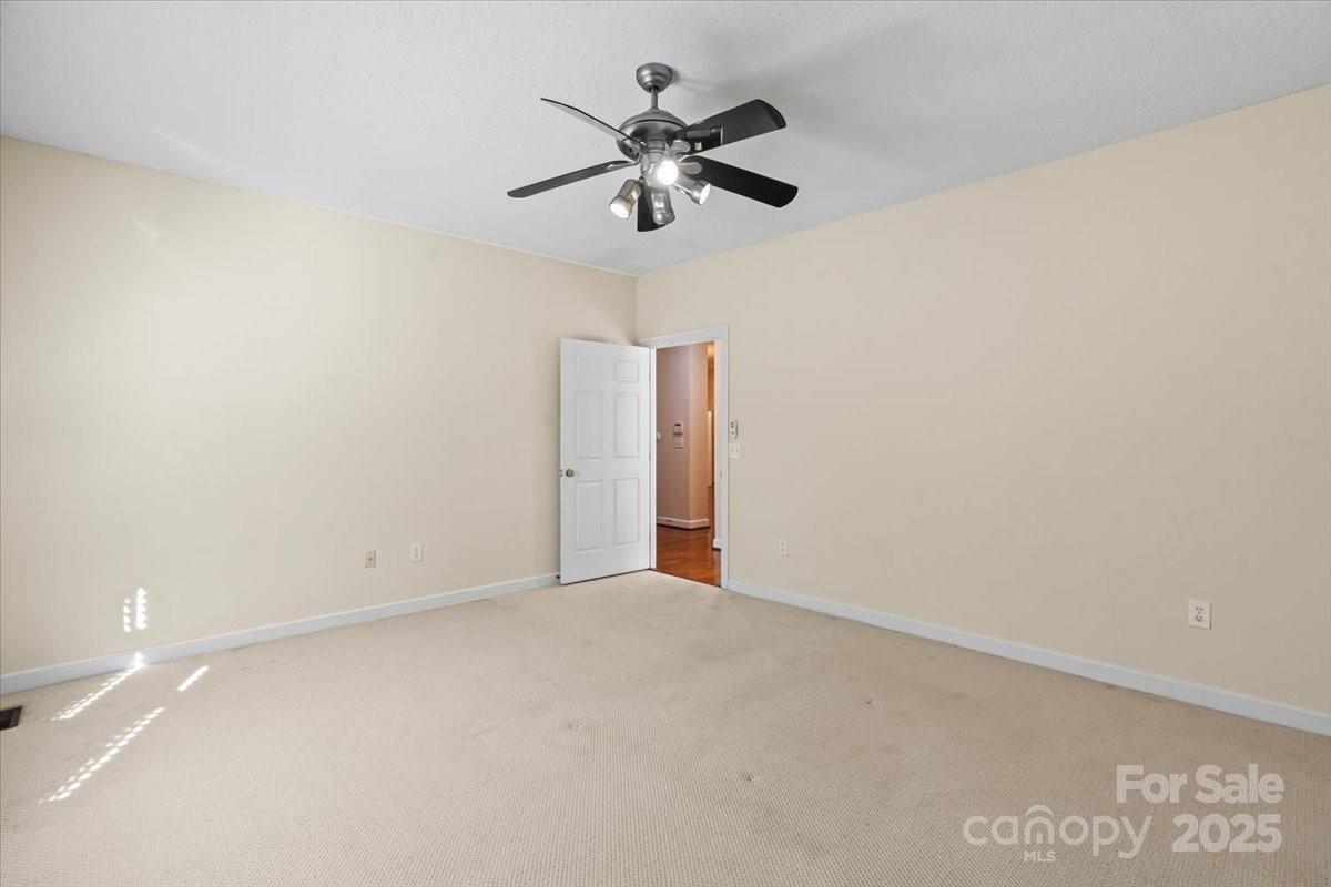 5619 Weddington Road Concord, NC 28027 - Photo 28 of 48 an empty room with ceiling fan and window