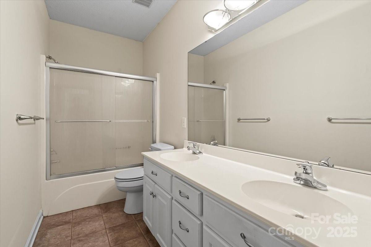 5619 Weddington Road Concord, NC 28027 - Photo 29 of 48 a bathroom with a granite countertop sink toilet and shower