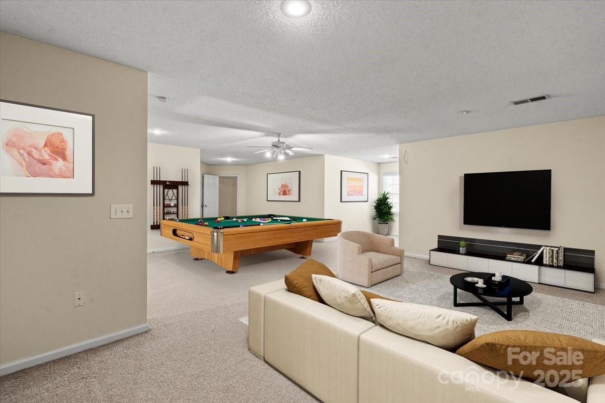 5619 Weddington Road Concord, NC 28027 - Photo 30 of 48 a living room with furniture and a flat screen tv