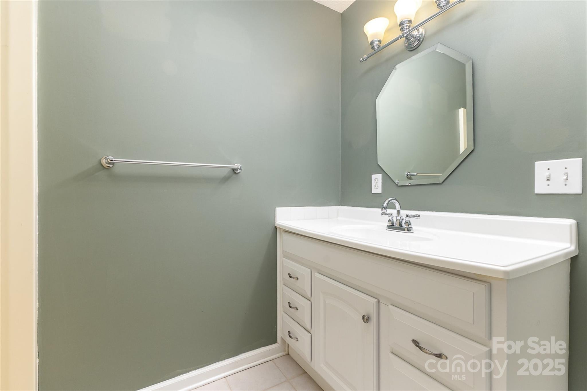 5619 Weddington Road Concord, NC 28027 - Photo 35 of 48 a bathroom with a sink and a mirror