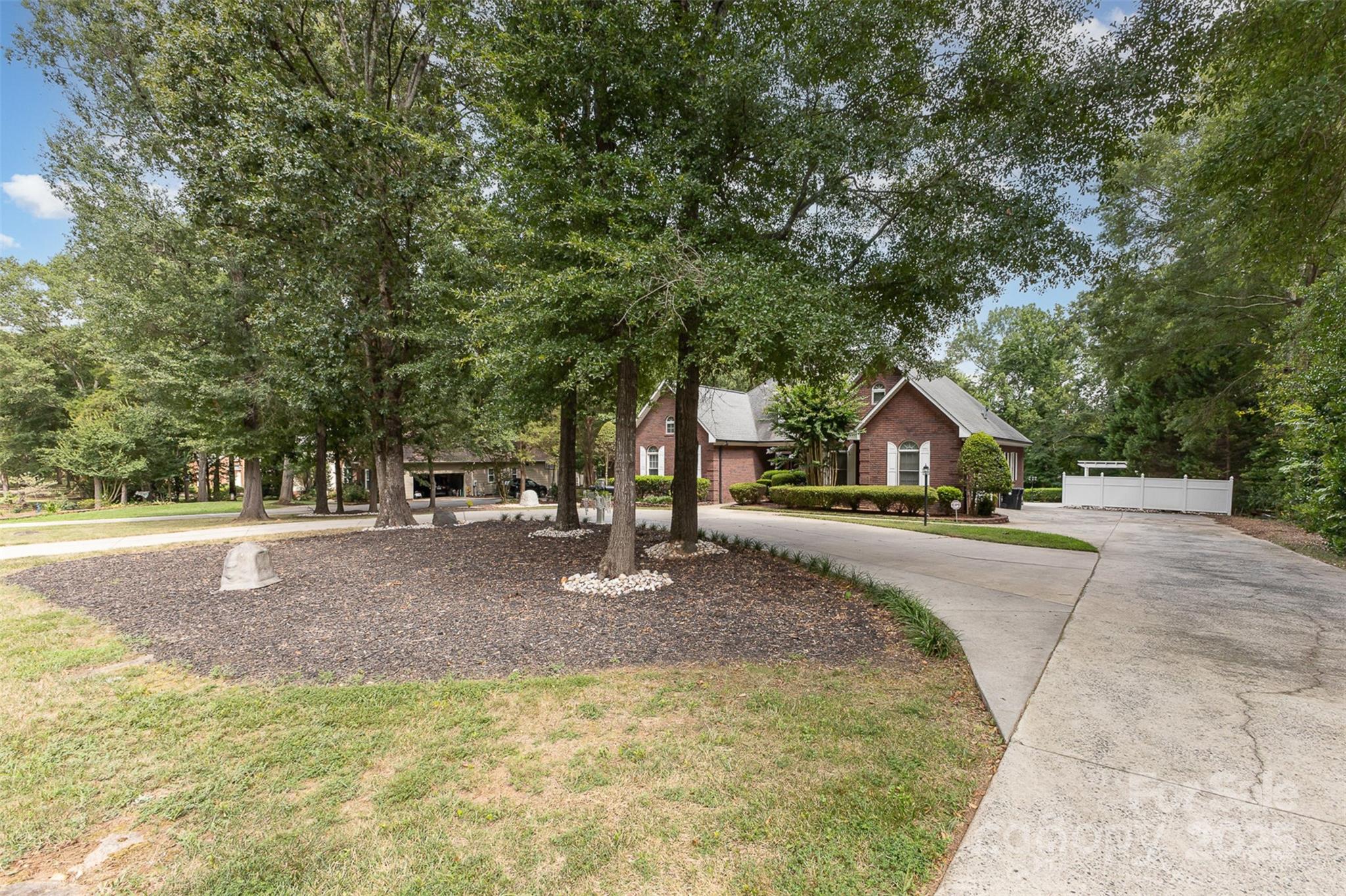 5619 Weddington Road Concord, NC 28027 - Photo 5 of 48 a house with trees in front of it