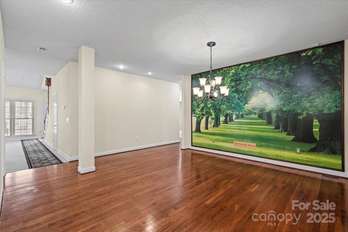5619 Weddington Road Concord, NC 28027 - Photo 10 of 48 a view of a living room and floor to ceiling window with wooden floor