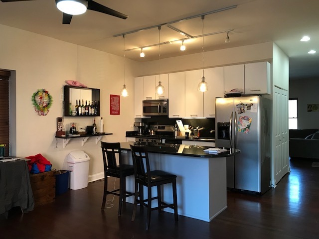 Undisclosed Address Chicago, IL 60614 - Photo 2 of 7 a kitchen with stainless steel appliances granite countertop a refrigerator a stove top oven a sink dishwasher and white cabinets with wooden floor