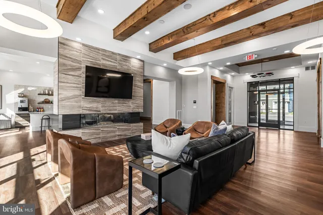 a kitchen with stainless steel appliances granite countertop a table and chairs