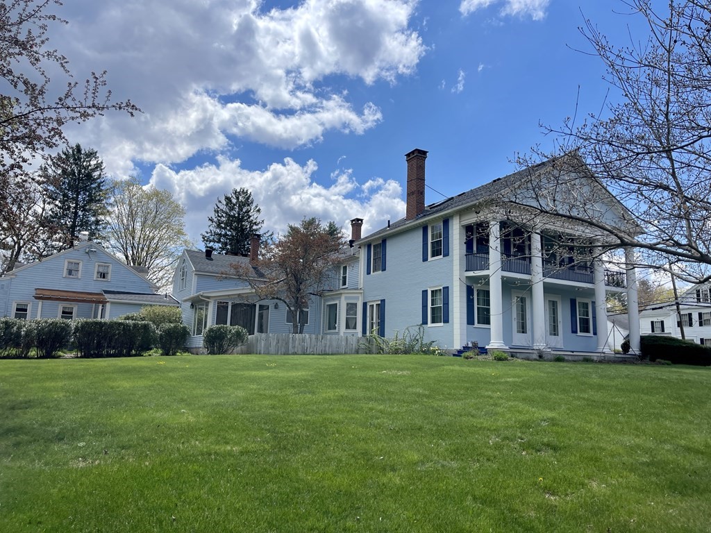 a front view of a building with a garden