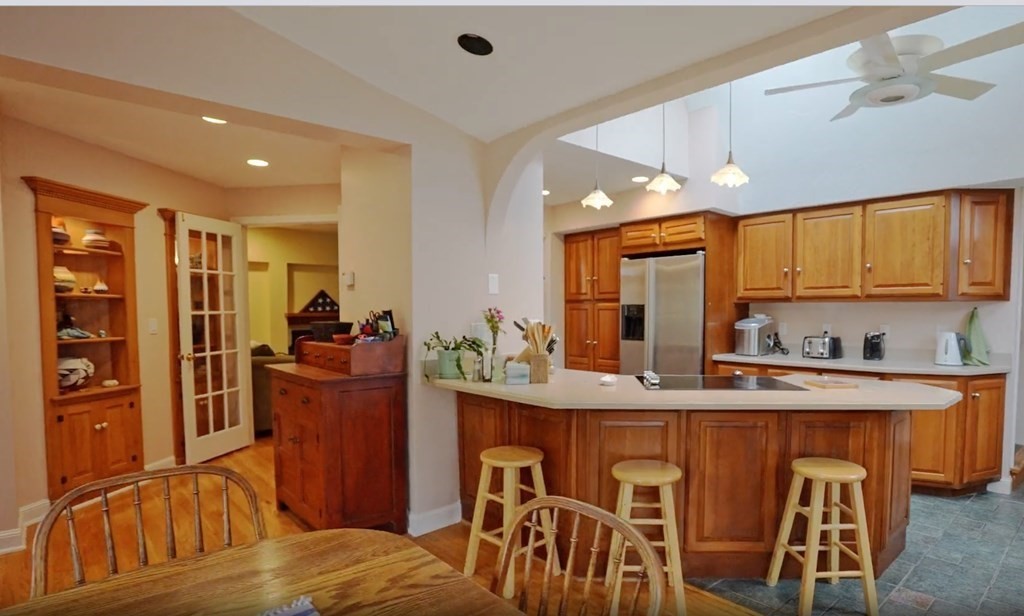 15 Wales Road Brimfield, MA 01010 - Photo 15 of 41 a kitchen with stainless steel appliances granite countertop a refrigerator a sink dishwasher a dining table and chairs with wooden floor