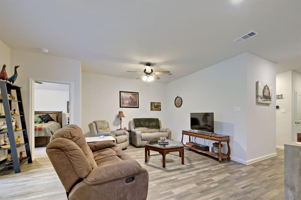 420 Jameson Springtown, TX 76082 - Photo 5 of 29 a living room with furniture a flat screen tv and a table